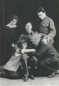 Myroslav Irchan (seated), as the son, in his play A Family of Brushmakers