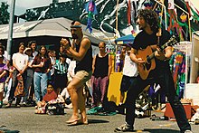 Artis (left) performing with Jim Page at Seattle's University District Street Fair (1993)