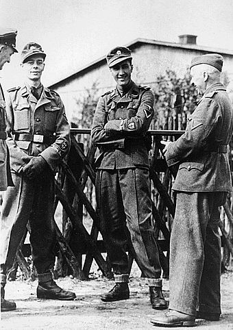 Two early recruits to the BFC: Kenneth Berry and Alfred Minchin, with German officers, April 1944