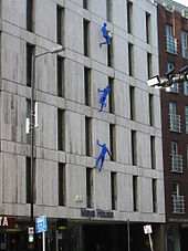 Blue Men by Ofra Zimbalista [he] climbing Maya House on Borough High Street (2007). Blue man borough london.jpg