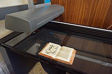 Image of a rare book in a book scanner where it will be digitized.