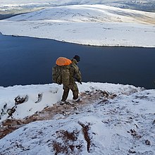 A soldier training in the Brecon Beacons above Llyn y Fan Fawr.