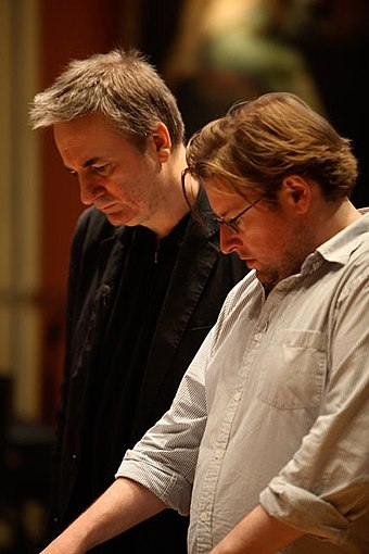 Paul Morley (left), a longtime critic of rockism, argued that many of poptimism's traits were indistinguishable from rockism.