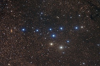 A picture of stars, with a group of appearingly bright blue and white stars. The bright stars together are identified as the asterism Coathanger resembling a coathanger, in the constellation Vulpecula. Cr399.jpg