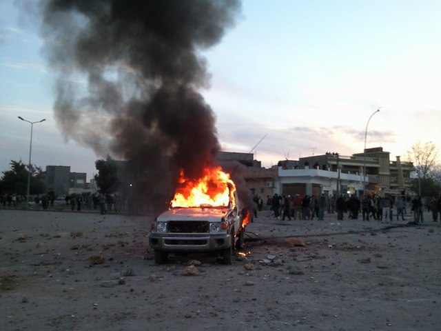 The first demonstrations in Bayda. A police car burns on 16 February 2011, at the crossroads of At-Talhi, now known as the Crossroads of the Spark.