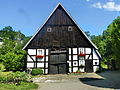 House, garage, barn and reading plaster in front of the barn's Deelentor