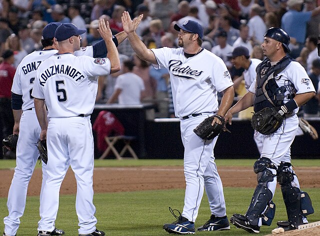 Heath Bell is congratulated by San Diego Padres teammates after a save in 2009