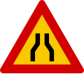 Road narrows on both sides