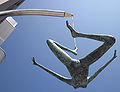 English: Jersey Girl, sculpture by Rowan Gillespie, commissioned by Harcourt Developments for Liberty Wharf development, Saint Helier, Jersey - inaugurated 2010. The sculpture is slightly larger than life size and is suspended by a cable connected to one of her toes. The sculptor was inspired by the Liberation of Jersey from WWII German Occupation.