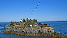 The rocky outcropping on which the lighthouse stands is cut off from Campobello Island during high tide. Lighthouse off Campobello Island (NB) September 2017 (38834375355).jpg