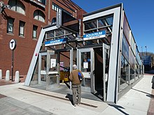 An angled glass entrance to a subway station