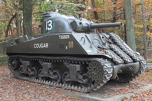 An M4 (105) Sherman tank with spare track-links welded on its front for additional armor protection, preserved at the Langenberg Liberation Memorial i