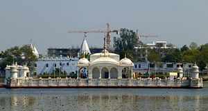 Large, white temple on the water