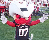 Raider Red showing the "Guns up" hand sign Raider Red Guns.jpg