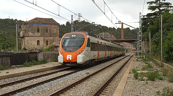 A Manresa-bound Civia train on a R4 limited service as it passes through the disused Els Comtals railway station, in 2014.