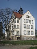 School and fairy tale fountain in front of the school