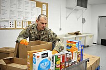 Sgt. Terry Boyd, assigned to the Ohio Military Reserve's Bravo Company 1st Battalion, packages meal boxes at the Toledo Northwestern Ohio Food Bank. Sgt. Boyd, Ohio Military Reserve's Bravo Company 1st Battalion, packages meal boxes.jpg