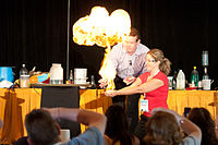 Steve Spangler igniting methane-filled bubbles in the hands of a young teacher at Science in the Rockies 2011. Steve Spangler and methane fire at Science in the Rockies 2011 SWC201107088547.jpg