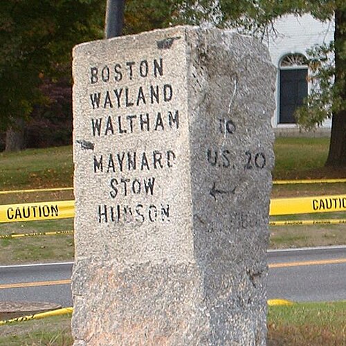 Granite road sign in Sudbury. The left side marks Route 27.