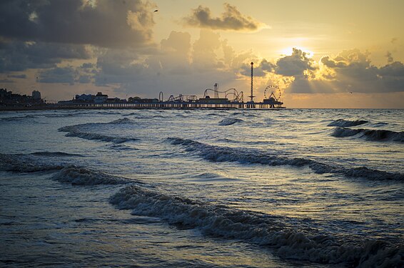 Sunset at Galveston Beach, Texas with Pleasure Pier in the distance