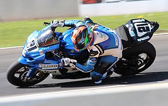 Elena Myers knee dragging while hanging off her Suzuki GSX-R1000 AMA Superbike at Road America. Superbike 21 Elena Myers leaning Road America 2015.jpg