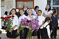 U.S. Air Force Master Sgt. Tammy Bean, an administrative assistant with the 376th Expeditionary Mission Support Group, stands for a photo with students attending Niznechuiskiy School 1 before a First Bell 120901-F-ER469-004.jpg