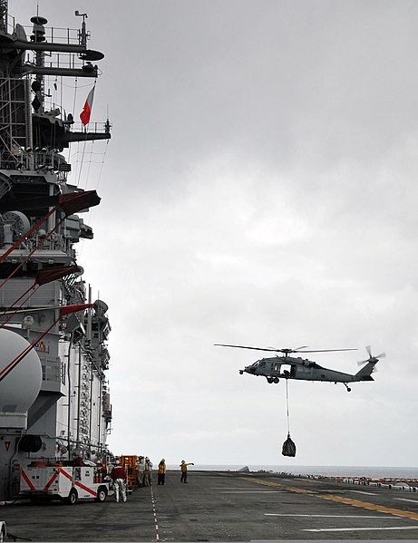 File:U.S. Sailors signal to an MH-60 Seahawk helicopter as it delivers supplies on the flight deck aboard the amphibious assault ship USS Boxer (LHD 4) during a vertical replenishment with the Military Sealift 110317-N-ZS026-016.jpg