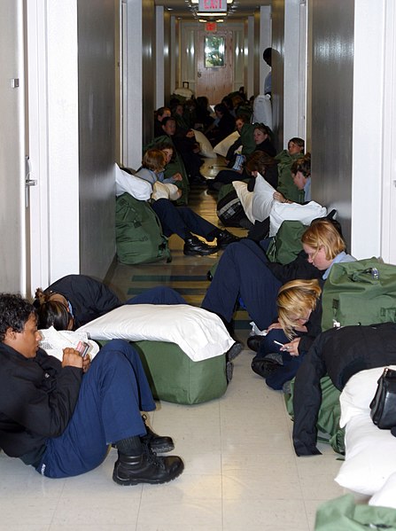 File:US Navy 040914-N-0000W-015 U.S. Navy students line the hall in a barracks while waiting to be evacuated from Naval Air Station Pensacola prior to Hurricane Ivan's arrival.jpg