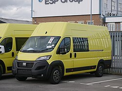 An unregistered 2022 Fiat Ducato featuring the new larger Fiat logo, built by Fiat to 'Veicolo Urgente' (Urgent Vehicle) specification and finished in British ambulance yellow, one of a large shipment of Ducatos stored in a storage yard near a Fiat dealership in Kingston upon Hull. These are likely to be converted to ambulances at the O&H Vehicle Technology facility in nearby Goole