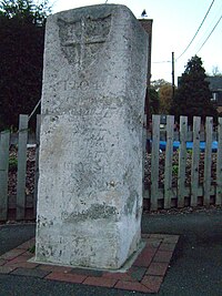 The Older London Stone standing in front of the fence of the Arethusa Venture Centre.