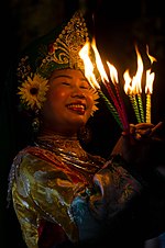 A dong cot is performing len dong. Vietnamese dancer with candles.jpg