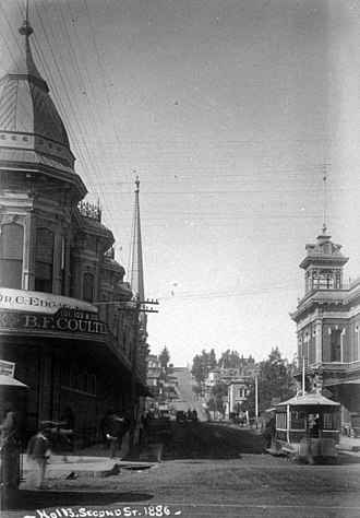View west on 2nd at Spring, with a cable car of the 2nd St. Cable Railway. Coulter's in the Hollenbeck Block (left) when it was only two stories tall; 2nd City Hall (right), 1886 View west on 2nd at Spring; Hollenbeck Block when two stories (left), 2nd City Hall (right), 1886.jpg