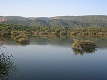 A lake nested within Aravali Hills.