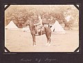 "Trooper R. J. Rogers" Photograph of a man on a horse, with tents behind them. (3599162184).jpg