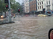 Flash flooding in the intersection of Flinders and Spencer Streets during the 2010 Melbourne thunderstorm. 2010 Melbourne storm flooding Spencer and Flinders Streets.jpg