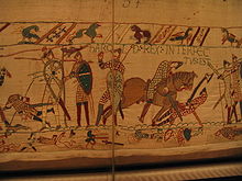 The Bayeux Tapestry, depicting the death of Harold II, 14 October 1066. His "Wyvern Standard" can be clearly seen at the left side. Bayeux Tapestry 3.jpg