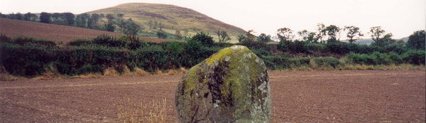 The Bendor stone at the site of the battle with Akeld Hill in the background. Humbleton Hill is out of shot to the left.