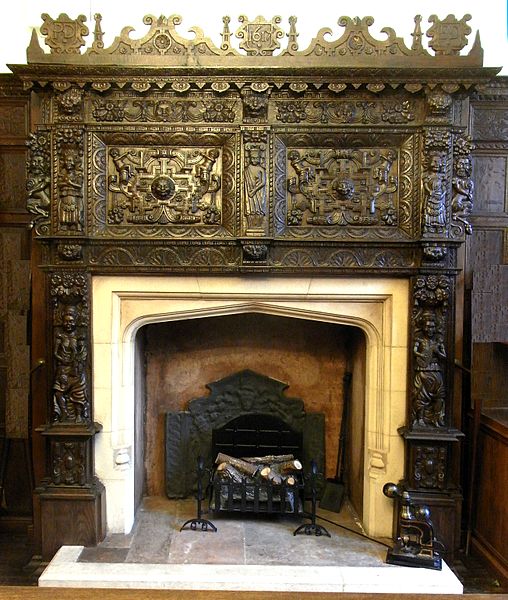 1617 carved oak chimneypiece formerly in the Dodderidge House, Cross Street, Barnstaple, decorated with two strapwork panels inhabited by putti and sh