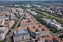 Aerial view of Pennsylvania Avenue NW facing east in 2007. Visible landmarks include the Old Post Office Pavilion (bottom center, with tower), the J. Edgar Hoover Building (center left, tan building), the National Gallery of Art (center rearground), and Market Square (middle left, with semicircular plaza). Federal Triangle - facing east.jpg