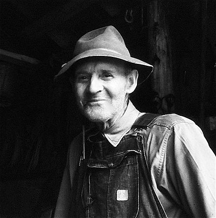 Ira W. Bolick, farmer and Camp Catawba's indispensable neighbor. Ira Bolick in barn.jpg