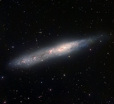 The irregular galaxy NGC 55, who is slowly spinning around and towards NGC 300, in the early stages of a lengthy merging process.