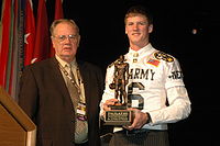 Mustain receiving the annual Hall Trophy from high school football legend Kenneth Hall. Kenneth Hall, Mitch Mustain.jpg