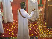 Flowers (in this instance marigolds) strewn about the sanctuary in an Oriental Orthodox church in Mumbai, India, on Palm Sunday Marigolds in the sanctuary.jpg