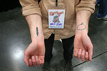 Political cartoonist Matt Bors displays his comics-themed tattoos at Stumptown Comics Fest in Portland, Oregon Matt Bors.jpg