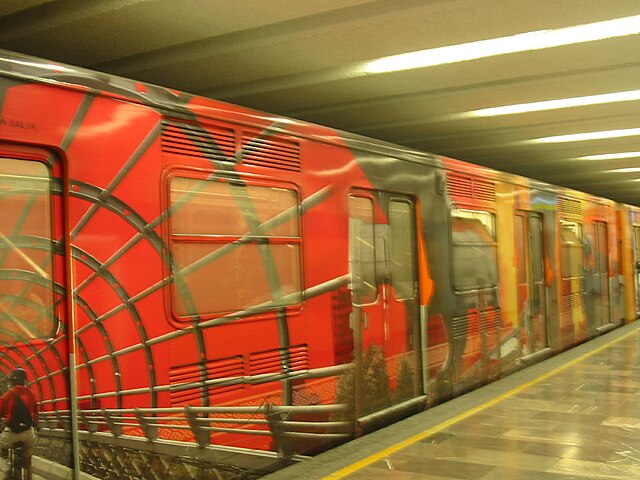 Mexico City Metro train in Bellas Artes station, decorated with images related to the city