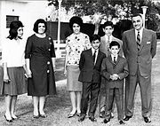 A group of related people posing outdoors