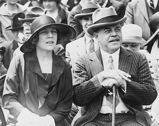 Nicholas Longworth and wife Alice seated outside the United States Capitol while watching a performance by Arizonan Native Americans, 1926.