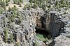 rock and tree dry barren large hole in remote area