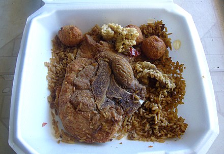 A pork chop served atop dirty rice