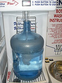 A bottled water refill station in a Canadian grocery store Refilling 18L water jug bottled water 5219.JPG